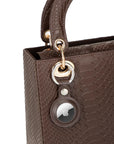 Leather air tag holder, brown, on a bag