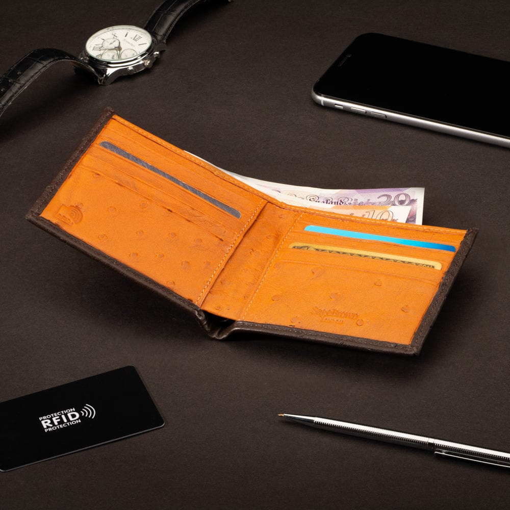 RFID wallet in ostrich leather, brown with orange, lifestyle