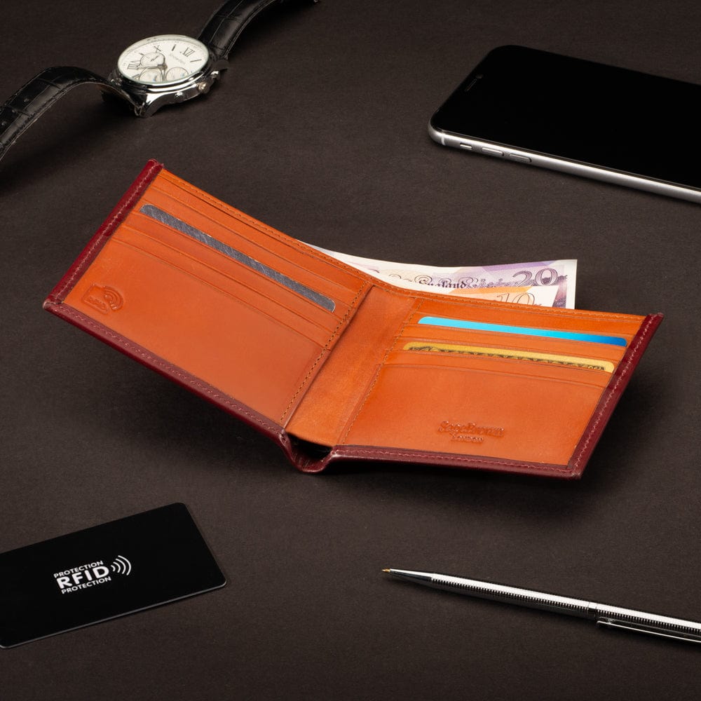 RFID wallet in bridle hide leather, burgundy with orange, lifestyle