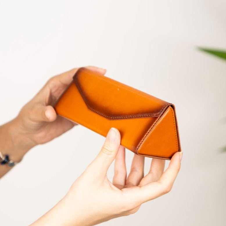 Triangular leather glasses case, burnished tan, lifestyle