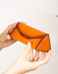 Triangular leather glasses case, burnished tan, lifestyle