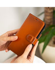 iPhone 15 Pro case in leather with RFID, burnished tan, lifestyle view