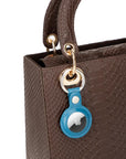 Leather air tag holder, blue, on a bag