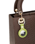 Leather air tag holder, lime green, on a bag