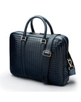 The Tressé leather laptop bag, navy woven, with shoulder strap