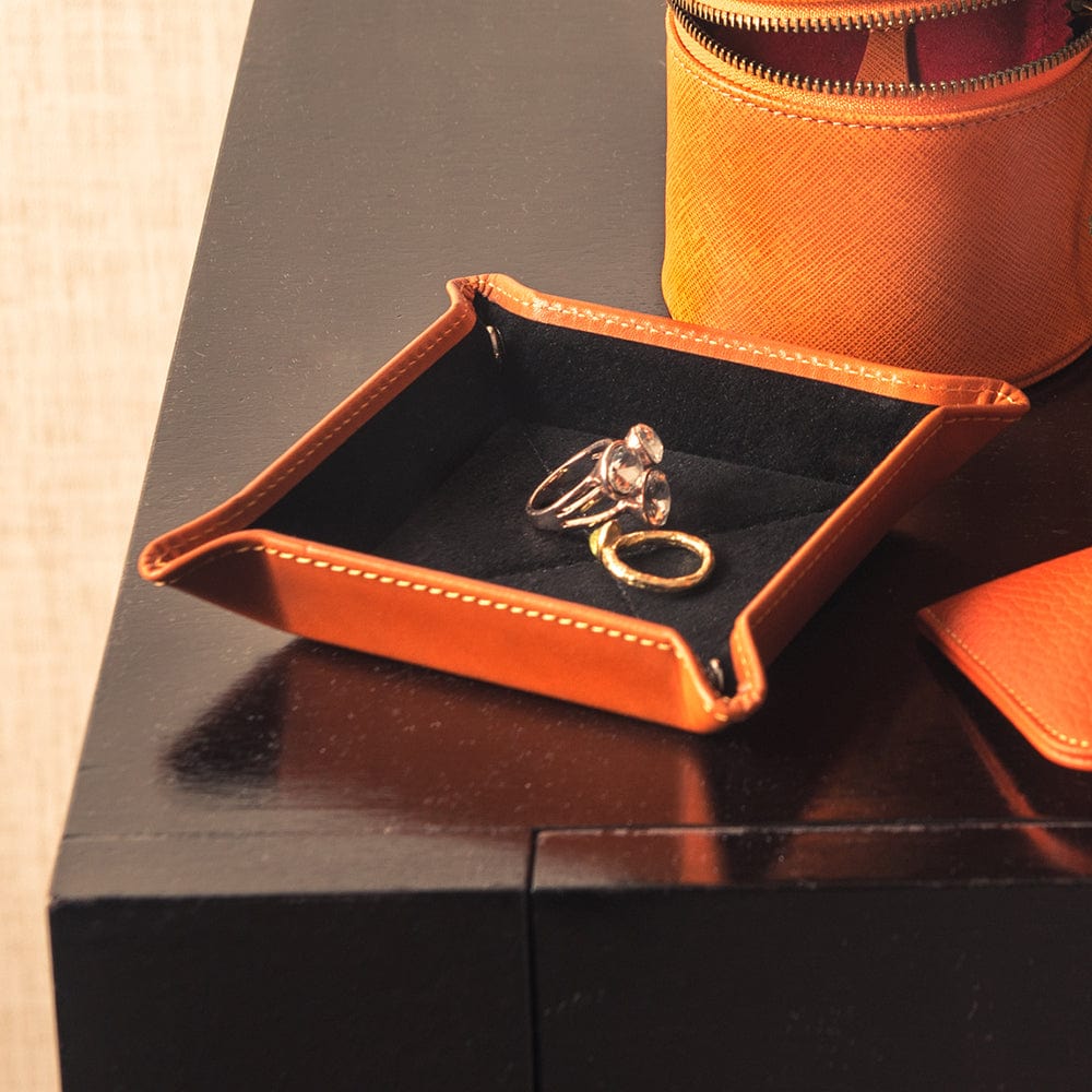 Leather valet tray, orange with black, lifestyle