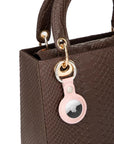 Leather air tag holder, pink, on a bag