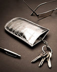 Leather key case with squeeze spring opening, silver croc, lifestyle