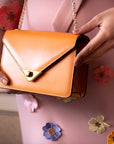 Mini leather chain envelope bag, orange, lifestyle view