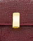 Leather top handle bag, burgundy croc, lock closeup