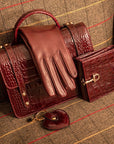 Leather purse with brass clasp, burgundy croc, lifestyle