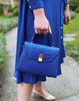 Sabrina top handle bag, cobalt croc leather, lifestyle image