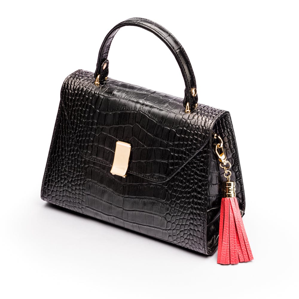 Decorative leather tassel, coral, on a bag