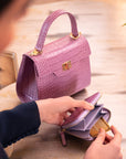 Small leather zip around accordion coin purse, lilac croc, lifestyle