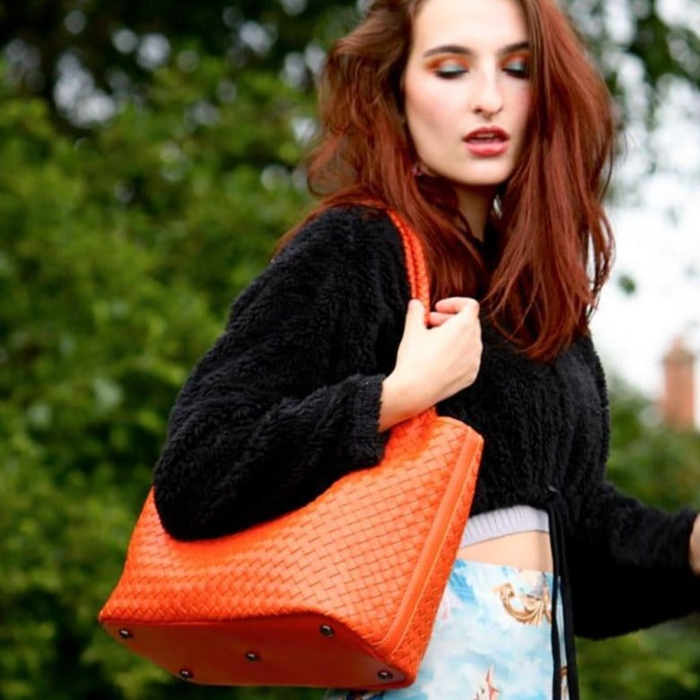 Woven leather shoulder bag, orange, lifestyle
