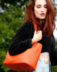 Woven leather shoulder bag, orange, lifestyle