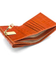 Leather purse with brass clasp, orange croc, inside