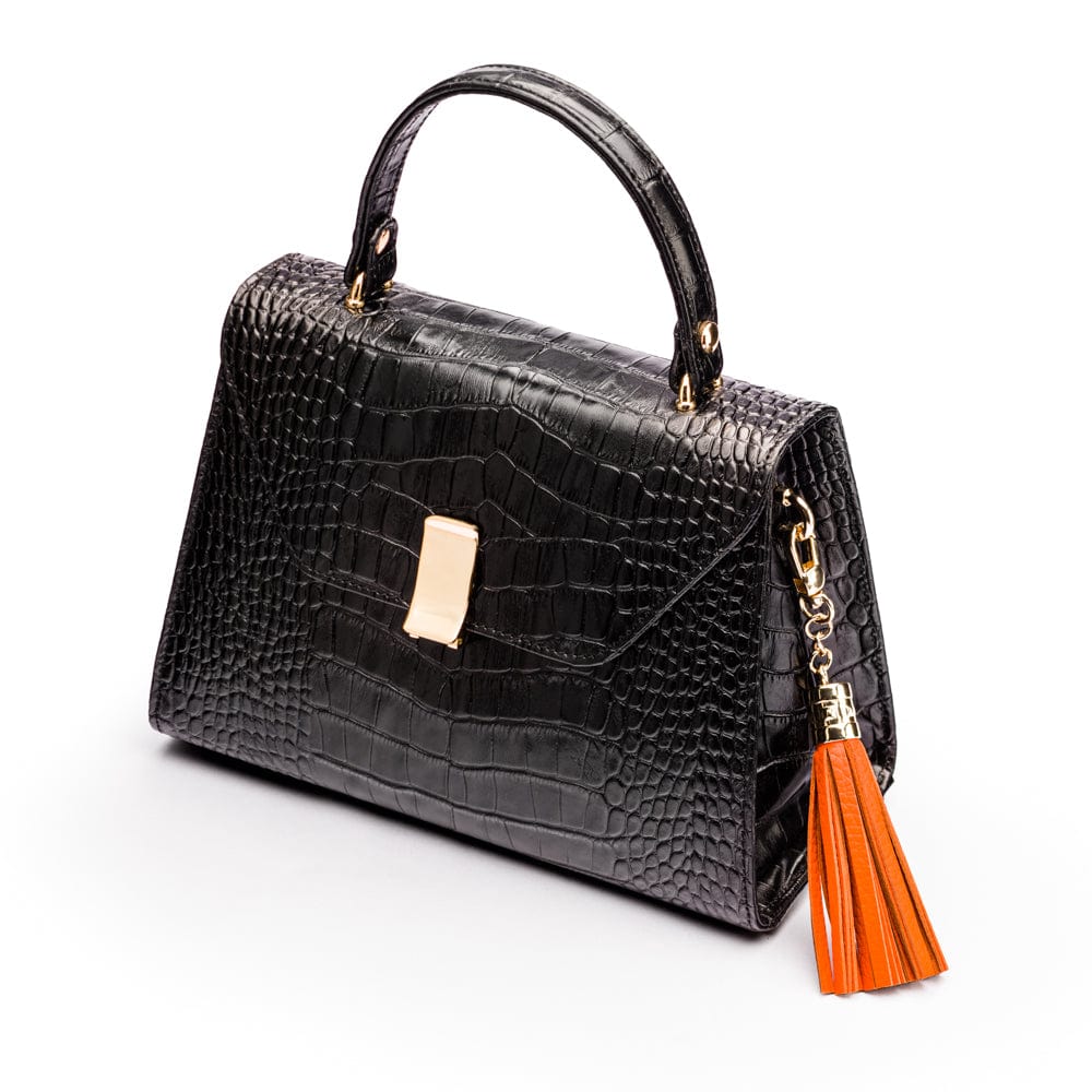 Decorative leather tassel, orange, on a bag