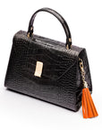 Decorative leather tassel, orange, on a bag