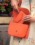Large leather purse with 15 CC, orange pebble grain, lifestyle