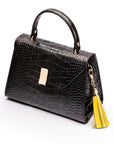 Decorative leather tassel, pale yellow, on a bag