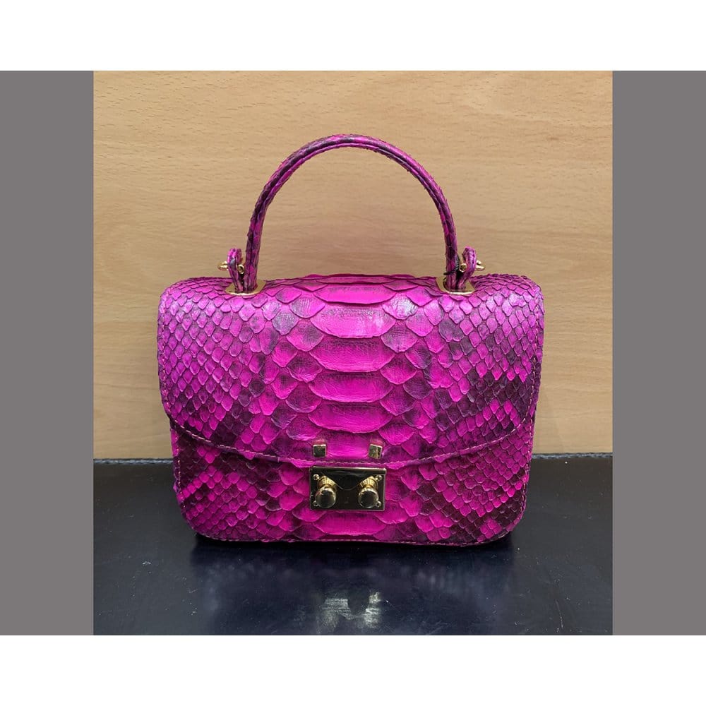 Small real python top handle bag, pink, front