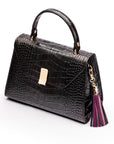 Decorative leather tassel, purple, on a bag