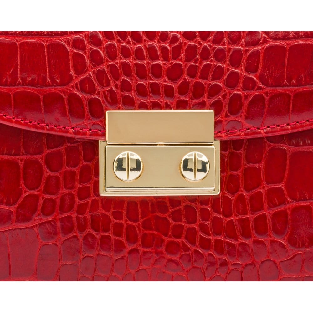 Small leather top handle bag, red croc, lock close up