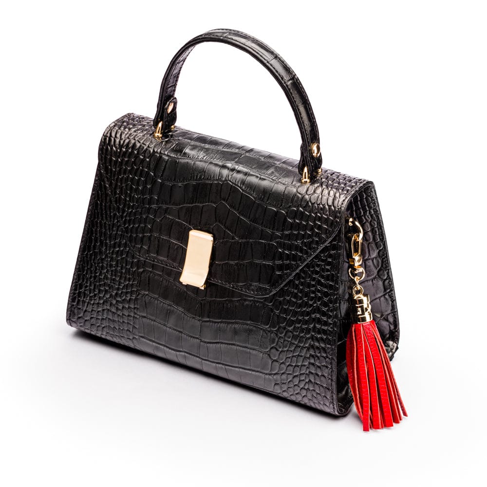 Decorative leather tassel, red, on a bag