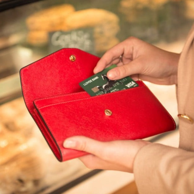 Leather accordion clutch purse with 12 card slots, red saffiano, lifestyle
