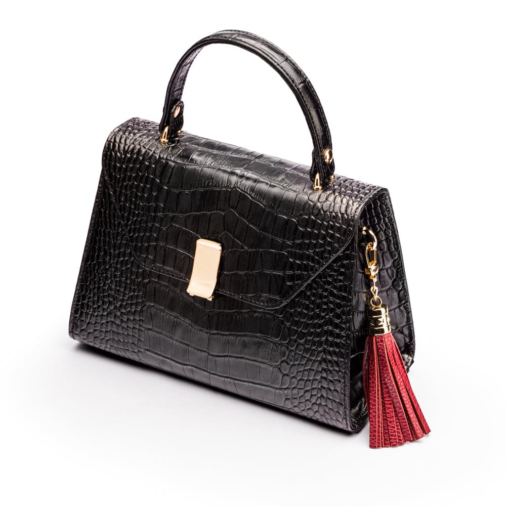 Decorative leather tassel, rust, on a bag