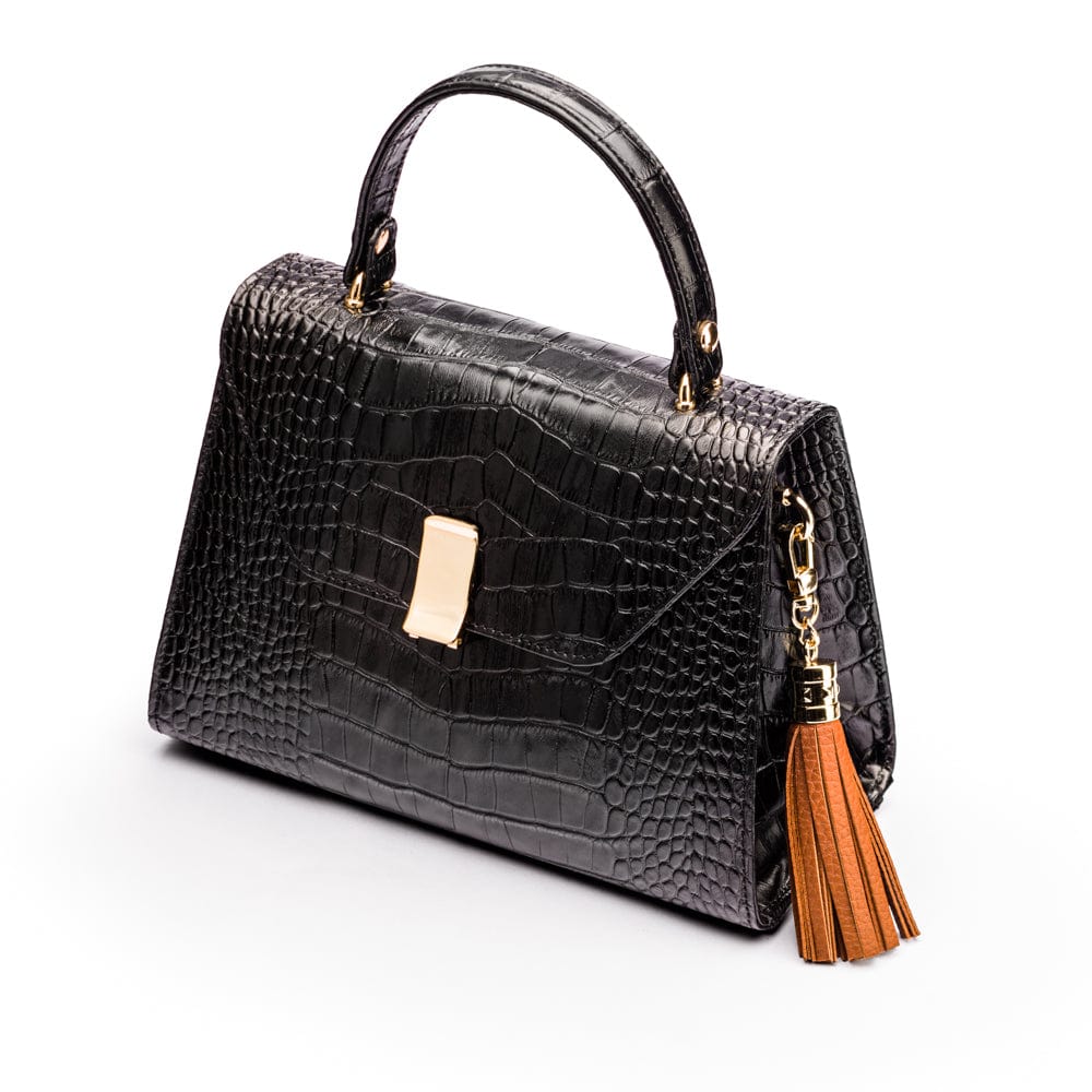 Decorative leather tassel, tan, on a bag
