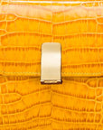 Leather top handle bag, yellow croc, lock closeup