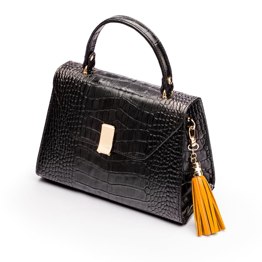 Decorative leather tassel, yellow, on a bag