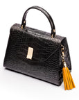 Decorative leather tassel, yellow, on a bag