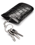 Leather key case with squeeze spring opening, black croc, open