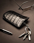 Leather key case with squeeze spring opening, black croc, lifestyle