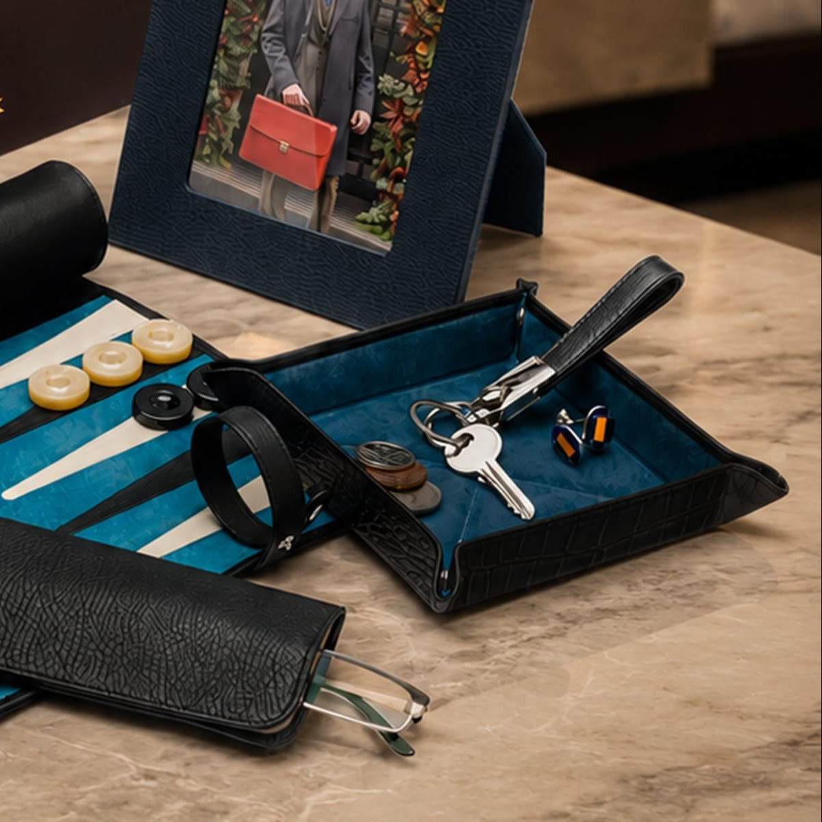 A luxury black leather key fob on a tray
