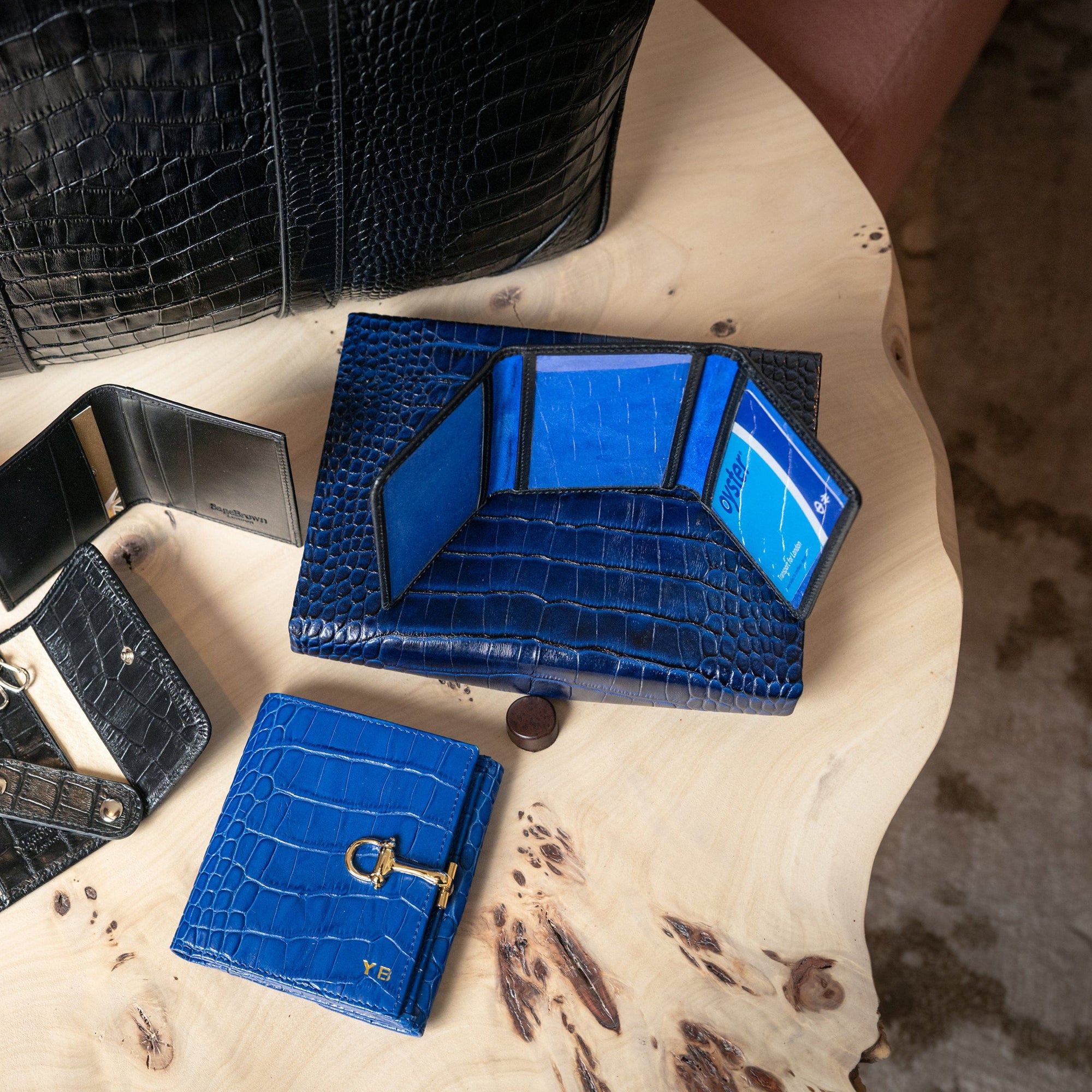 Leather tri-fold travel card holder, black with cobalt, lifestyle