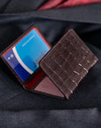 Leather tri-fold travel card holder, brown croc with red, lifestyle