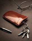 Leather key case with squeeze spring opening, dark tan, lifestyle