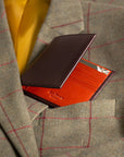 Men's leather billfold wallet, brown with orange, lifestyle