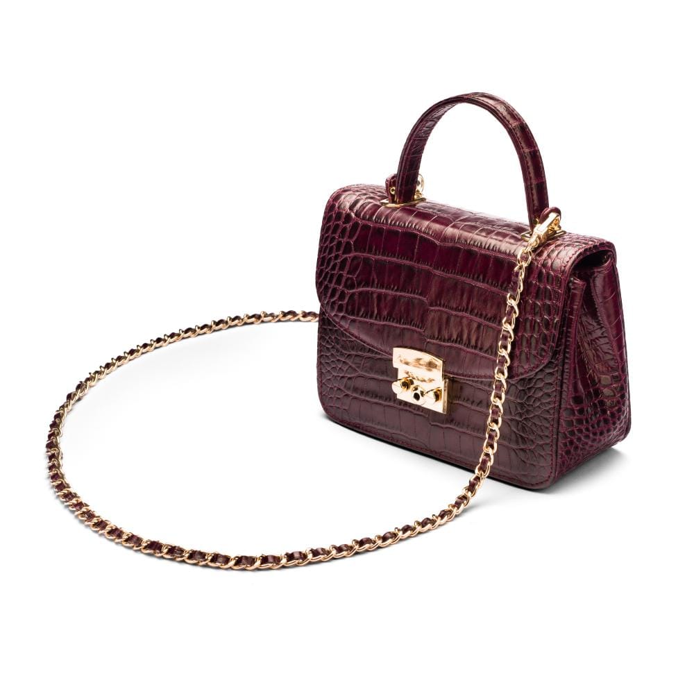 Small leather top handle bag, burgundy croc, side