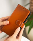 iPhone 15 case in leather with RFID - burnished tan, lifestyle