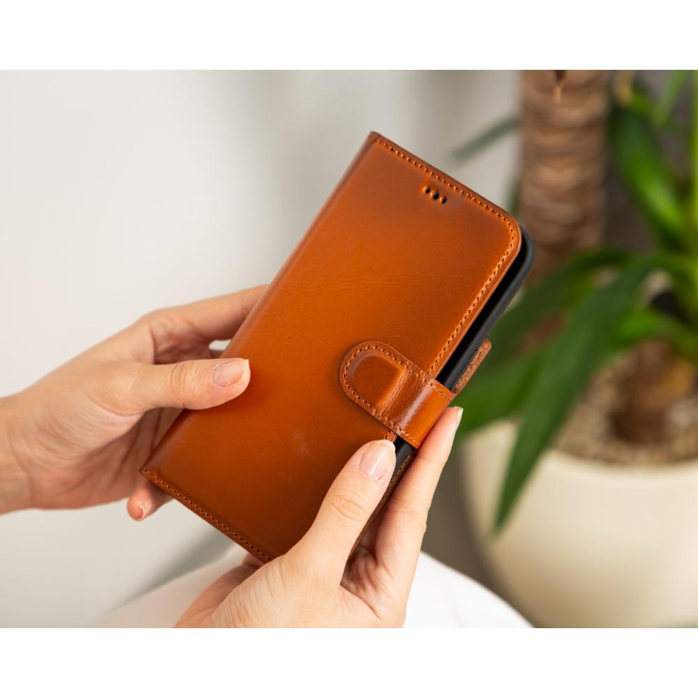 iPhone 15 Pro case in leather with RFID, burnished tan, lifestyle view