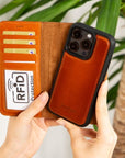 iPhone 15 Pro Max case in leather with RFID protection, burnished tan, lifestyle