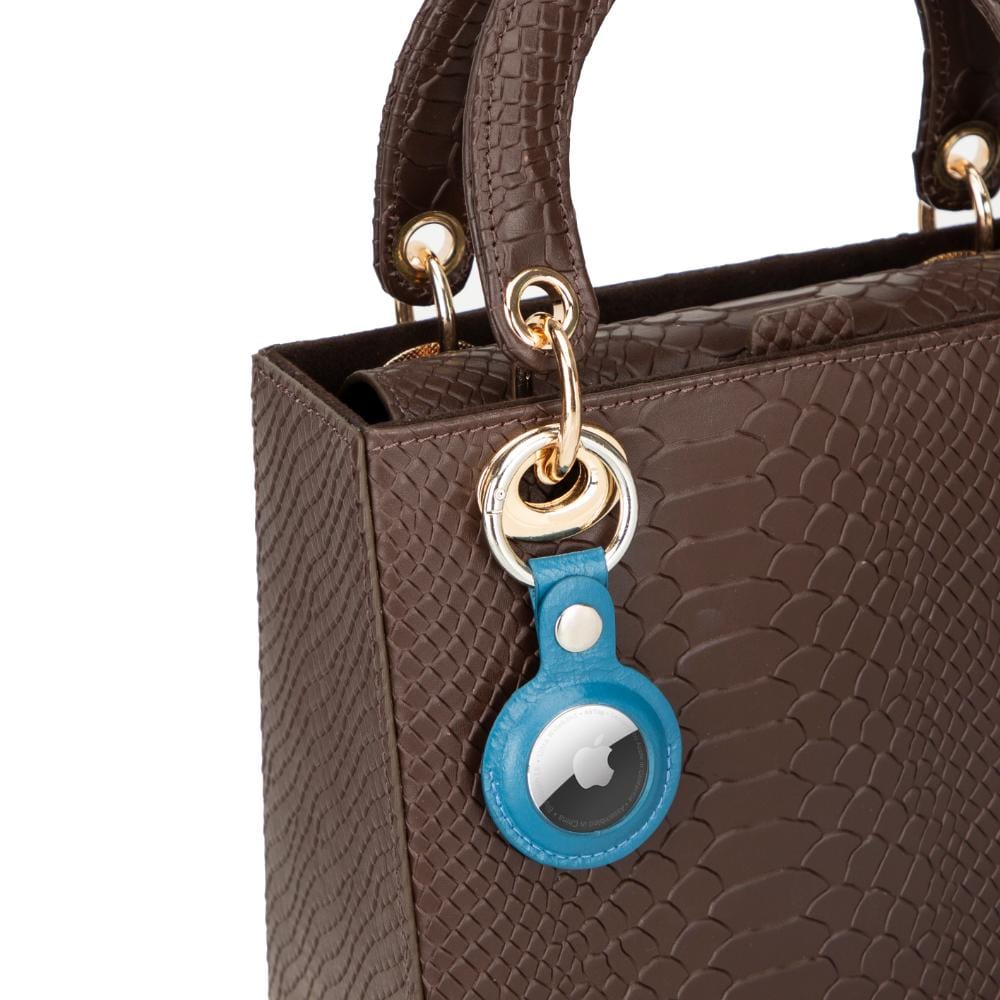 Leather air tag holder, blue, on a bag