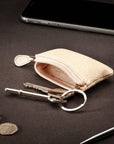 Miniature leather coin purse with key chain, cream, lifestyle