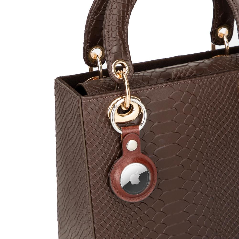 Leather air tag holder, tan, on a bag