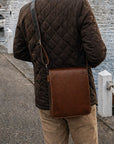 Small leather messenger bag, dark tan, lifestyle